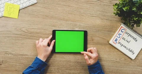Close up of the woman's hands using the black horizontal tablet computer with a Video stock 89977474