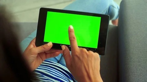 Close up of woman`s hands using green screen chroma key in the bedroom Stock Footage 73814517