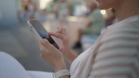 Close up of woman's hands using modern smartphone, tapping and scrolling on.. Stock Footage 339782031