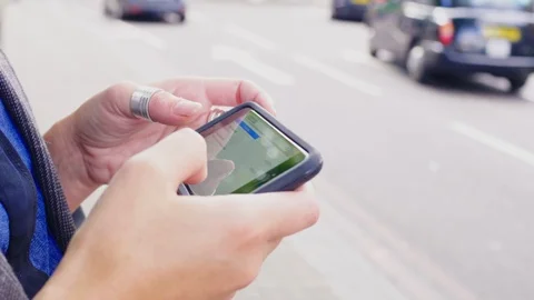 Close up of woman's hands using smart phone on street Stock Footage 86068814