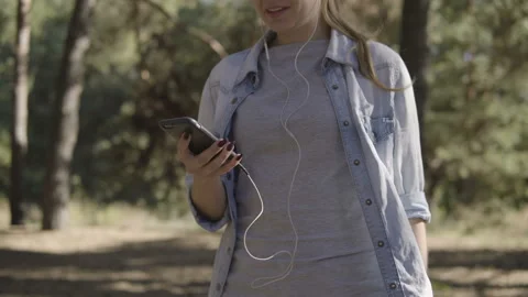 Close Up of Woman's Hands Using Smartphone In sunny coniferous forest. Stock Footage 95808777