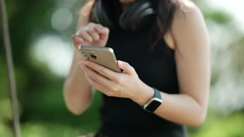 Close Up of Woman's Hands Using a Smartphone in a Natural Outdoor Setting. Stock Footage 316657462