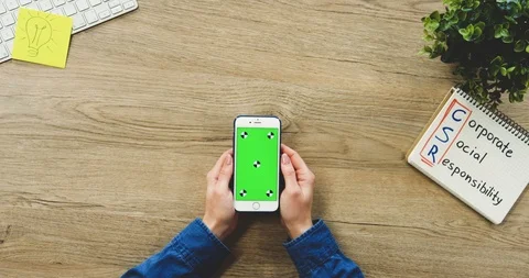 Close up of the woman's hands using the white vertical smartphone with a green Stock-Footage 89976624