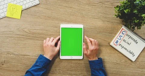 Close up of the woman's hands using the white vertical tablet computer with a Video stock 89978459