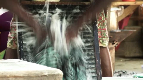 Close-up of woman's hands washing clothes on a washboard outdoors. Stock Footage 210214565