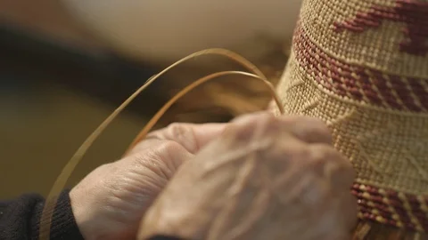 Close up of womans hands weaving a hat Stock Footage 104867193