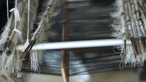 Close-up of woman's hands weaving yarn by using mechanic wooden machine to weave Stock Footage 305613675