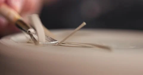 Close-up of woman's hands which shaping workpiece with a tool in a pottery Stock Footage 155412209