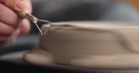 Close-up of woman's hands which shaping workpiece with a tool in a pottery Stock Footage 155412320