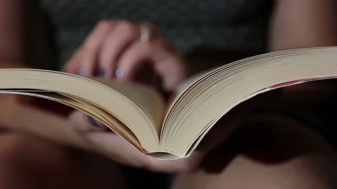 Close up, woman's hands while leafing through a book Video stock 116337409