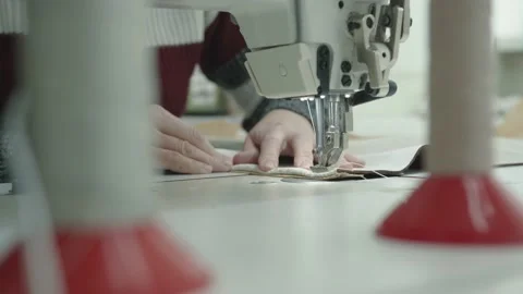Close-up of a woman's hands at work on a sewing machine in an upholstered Stock Footage 150805470