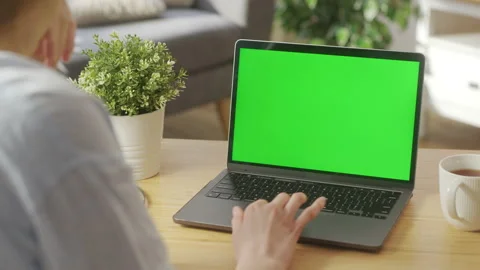 Close-up of a Woman's Hands Working on Green Screen on a Laptop Scrolling Видео 172027532