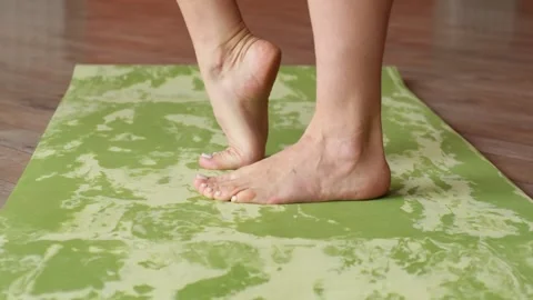 Close-up of a woman's legs doing a warm-up on a sports mat Stock Footage 282513819
