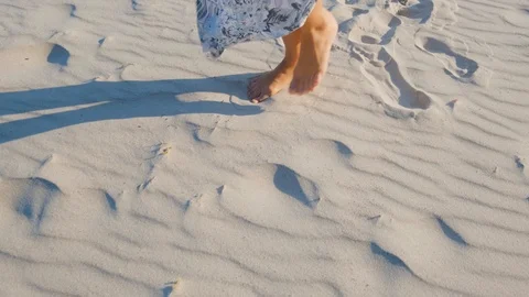 Close up of womans legs on the sand Stock Footage 117230949