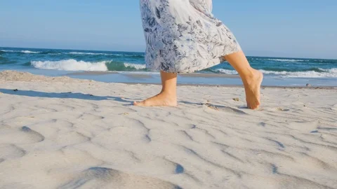 Close up of womans legs on the sand Stock Footage 117231004