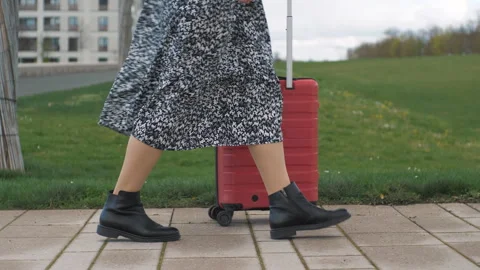 Close-up of the woman's legs stand still and start walking forward with suitcase Stock Footage 272171467