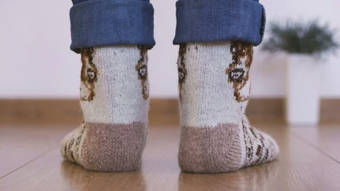 Close-up of woman's legs in warm woolen socks doing gymnastics lifting the body Stock Footage 102932470
