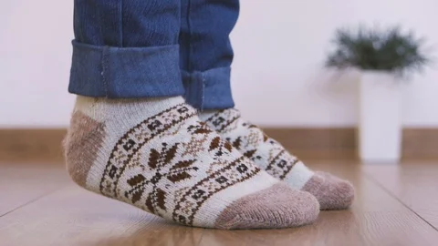 Close-up of woman's legs in warm woolen socks doing gymnastics lifting the body Stock Footage 102933377