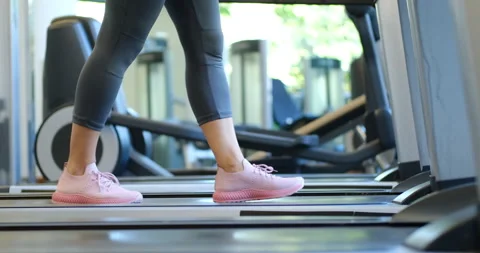 Close up of woman's legs working out in gym doing cardio training walking slowly Stock-Footage 130874947