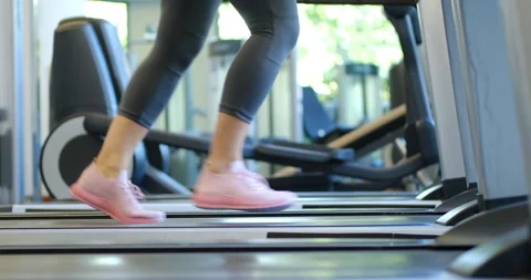 Close up of woman's legs working out in gym doing cardio training running on 스톡 동영상 130875230