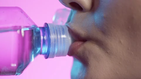 Close Up Of Woman's Mouth Lips Drinking Water From Plastic Bottle With Stock Footage 277870517