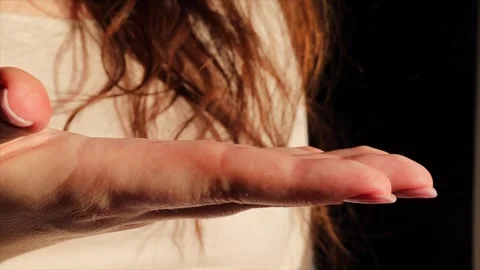 A close-up of a woman's open hand against a dark background, with soft lighting Stock Footage 303850405