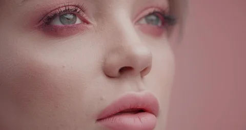 Close up of Woman’s strong Face in front of Camera, having creative Makeup Stock Footage 126157589