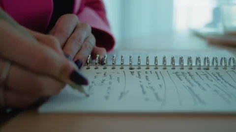 Close up women making notes in the notebook with a pen. Stock Footage 263284428