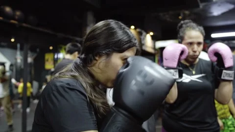 Close up of women practicing boxing punches together during fitness training Stock Footage 340923926