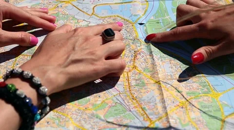 Close up of women's arms pointing map with fingers Stock Footage 64965064