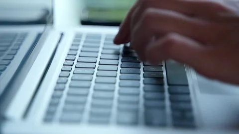 Close-up of women's brushes that quickly type on a laptop Stock Footage 234021338