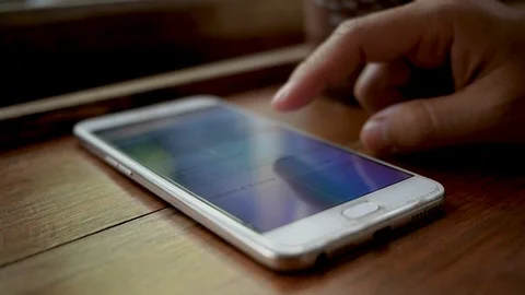 Close-up of women's finger touch screen on smartphone to relax in the cafe. Stock Footage 127736653