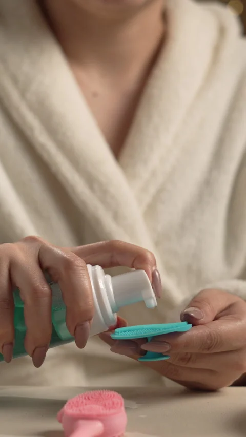 Close-up of women's hands applying special cosmetic foam to a facial cleans.. Stock Footage 339342386