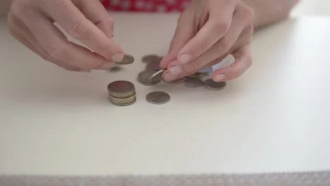 Close-up, women's hands counting metal coins on the table Stock Footage 240033131