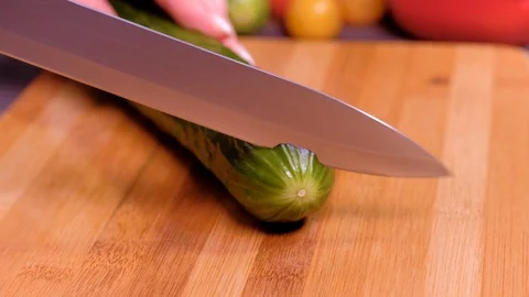 Close up women's hands cut cucumber Stock Footage 123357202