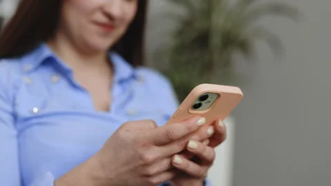 Close up of women's hands holding cell telephone text message or promotional Video stock 242611546