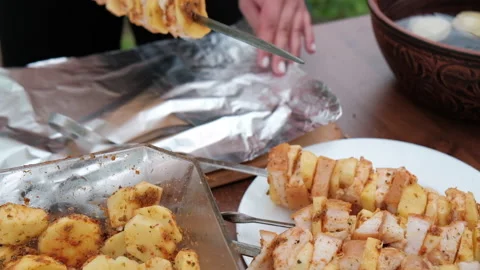 Close-up of women's hands that make kebab with potatoes and lard Video stock 194542624