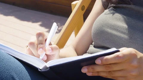 Close-up of women's hands making notes in a notebook Stock Footage 111414729