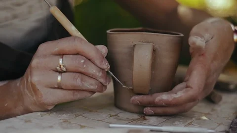Close-up, Women's Hands of the Potter Process Tool Handle on Clay Mug Stock Footage 123006929