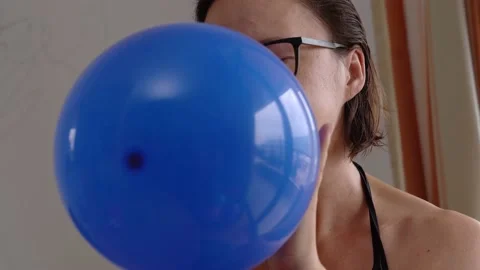 Close-up of women's hands quickly pick up colored balloons to inflate them for Stock Footage 201607268