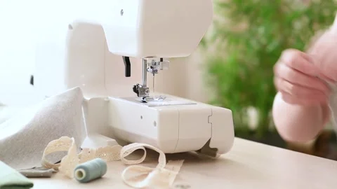 Close-up of women's hands that sew on a sewing machine Stock Footage 183610906