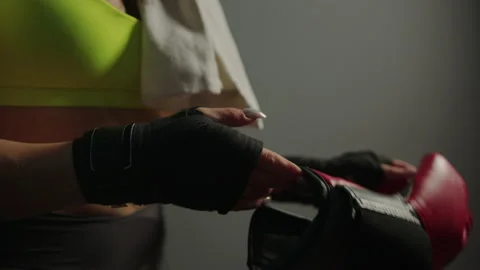 Close-up of women's hands taking off boxing gloves after training Stock Footage 197016772