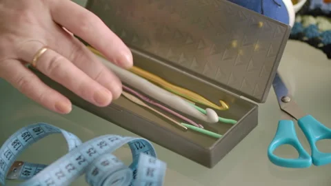 Close-up of women's hands taking out a knitting hook from a box Stock Footage 166902674