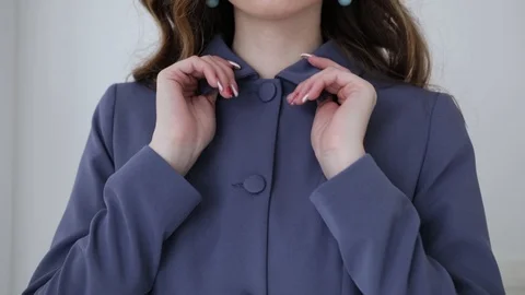 Close-up of women's hands touching the collar of the blue jacket Stock Footage 102379337