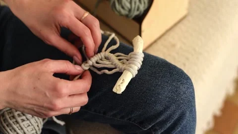 Close up of women's hands weaving macrame in a home workshop. Stock Footage 154095844