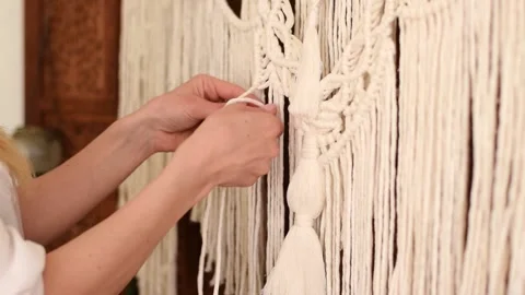 Close up of women's hands weaving macrame in a home workshop. Stock Footage 154342763