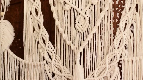Close up of women's hands weaving macrame in a home workshop. Stock Footage 154342924