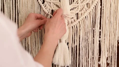 Close up of women's hands weaving macrame in a home workshop. Stock Footage 154342954