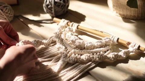 Close up of women's hands weaving macrame in a home workshop. Stock Footage 154343302