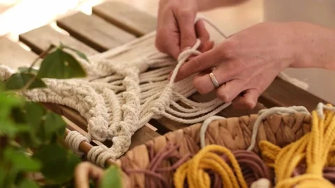 Close up of women's hands weaving macrame in a home workshop. Stock Footage 154343390